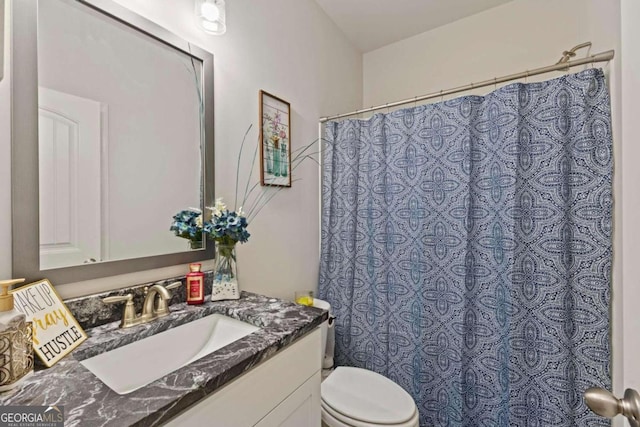 bathroom with vanity, a shower with curtain, and toilet