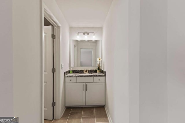 corridor featuring sink and light hardwood / wood-style flooring