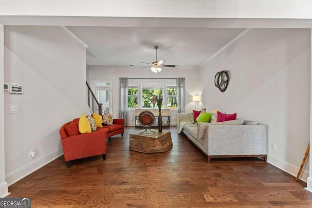 living room with crown molding, dark hardwood / wood-style floors, and ceiling fan