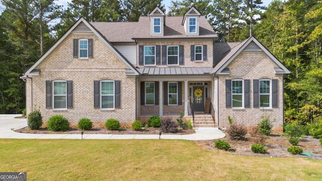 view of front facade with a front yard and a porch