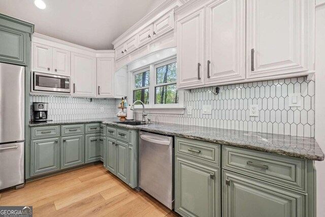 kitchen with sink, white cabinets, and stainless steel appliances