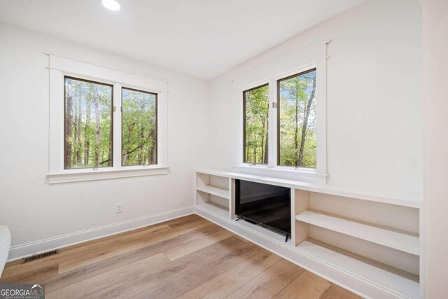 unfurnished living room featuring light hardwood / wood-style floors