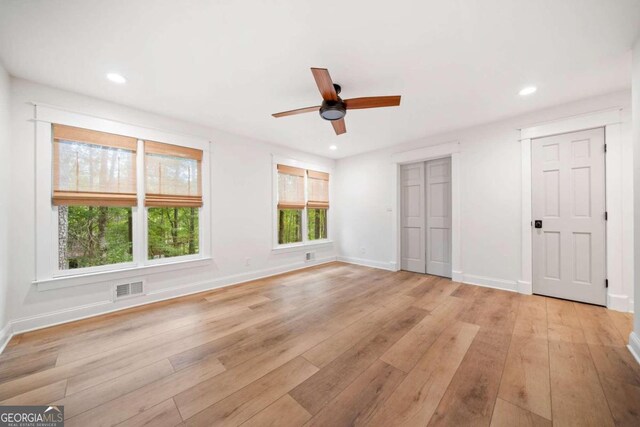 unfurnished bedroom with ceiling fan and light hardwood / wood-style flooring