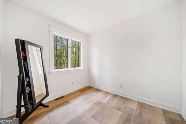 spare room with light hardwood / wood-style floors