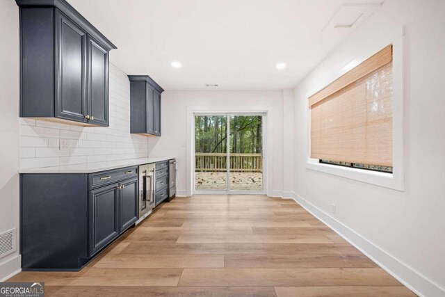 kitchen with decorative backsplash and light hardwood / wood-style flooring