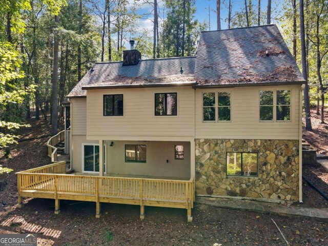 rear view of property featuring a deck