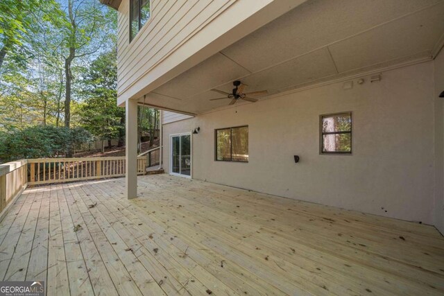 wooden deck featuring ceiling fan