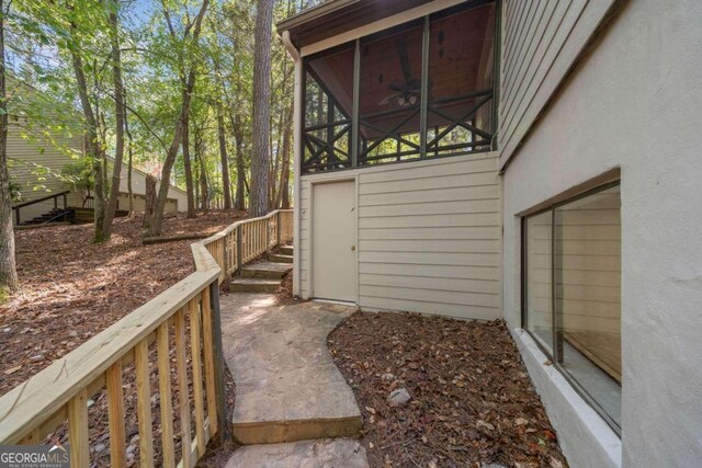 exterior space featuring a sunroom and ceiling fan