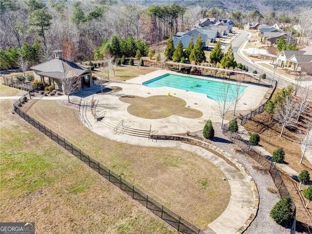 view of swimming pool featuring a lawn and a patio