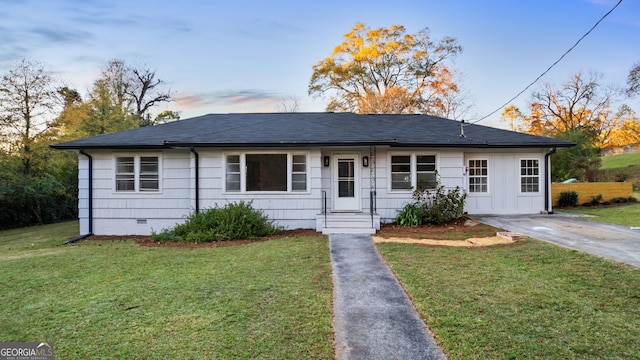 ranch-style home with a yard