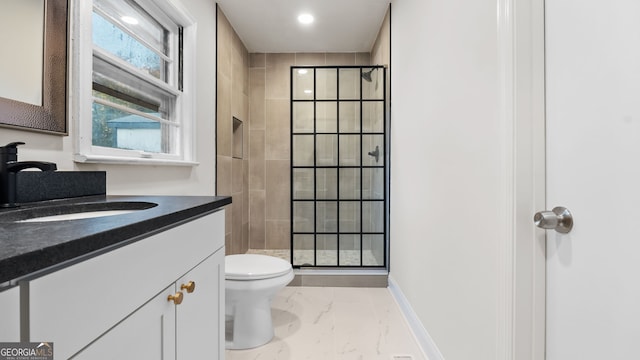 bathroom with vanity, toilet, and a shower with shower door