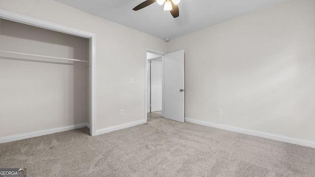 unfurnished bedroom with ceiling fan, a closet, and light colored carpet