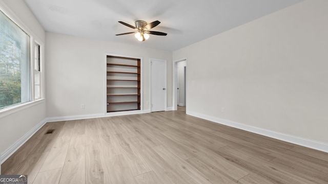 unfurnished bedroom featuring light wood-type flooring and ceiling fan