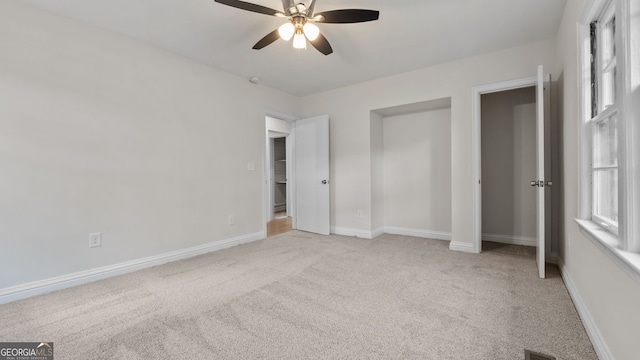 unfurnished bedroom featuring light colored carpet and ceiling fan