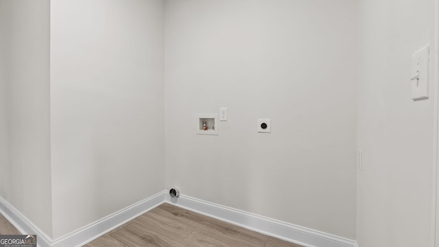 clothes washing area featuring hookup for an electric dryer, light wood-type flooring, and washer hookup