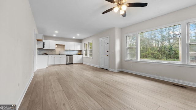 unfurnished living room with a wealth of natural light and light hardwood / wood-style flooring