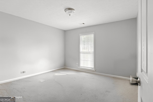 spare room with light carpet