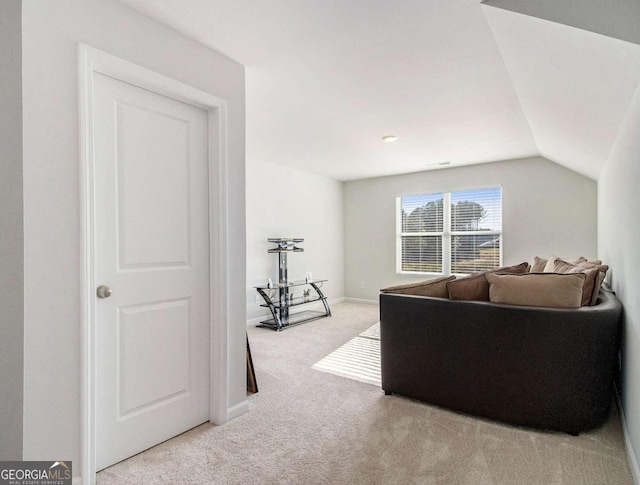 living room with light colored carpet and lofted ceiling