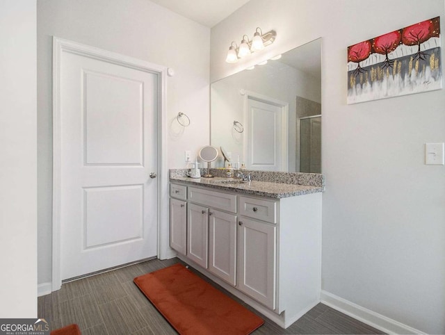 bathroom with vanity and a shower with shower door