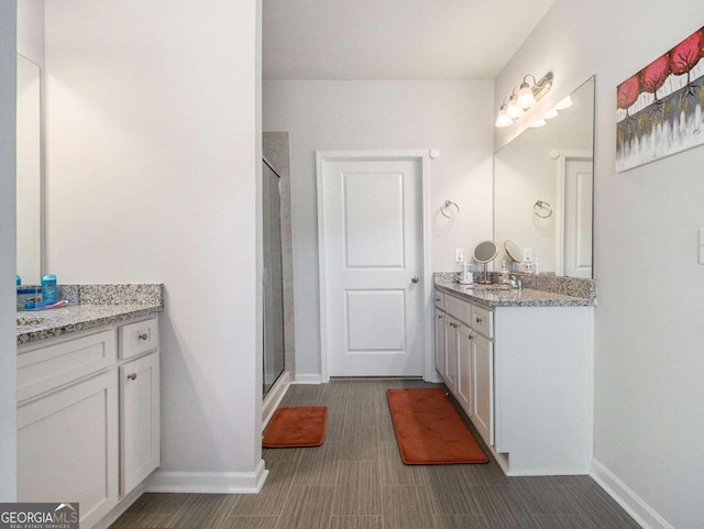 bathroom featuring vanity and a shower with shower door