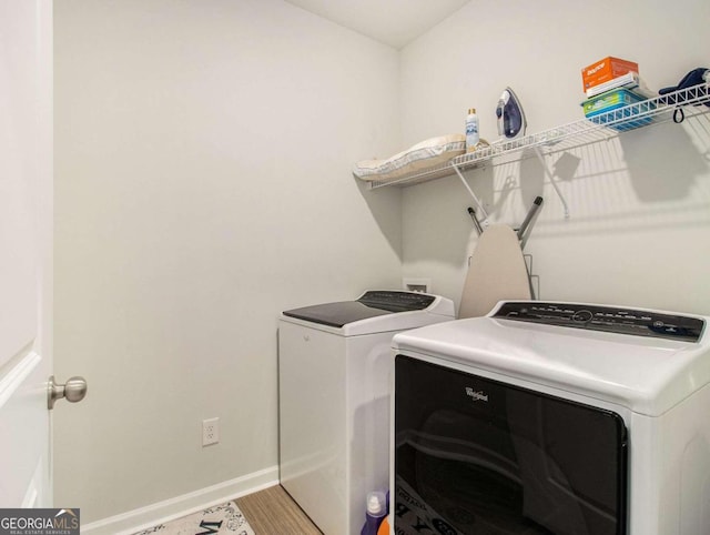 laundry room featuring wood-type flooring and independent washer and dryer