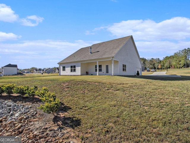 rear view of property featuring a yard