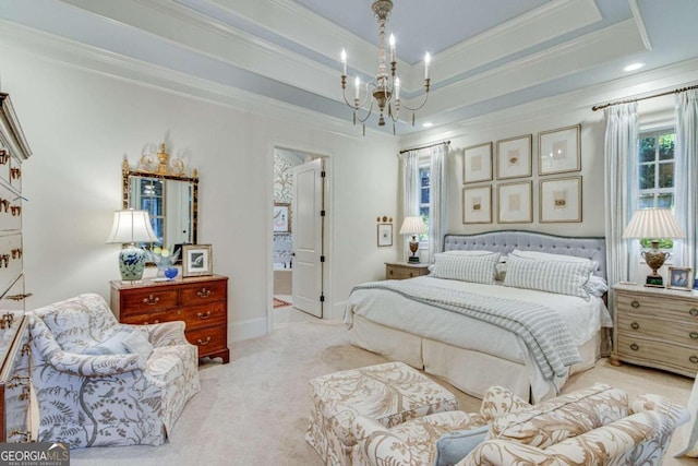 carpeted bedroom with an inviting chandelier, ornamental molding, and a tray ceiling