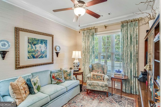 living room featuring hardwood / wood-style floors, crown molding, and ceiling fan