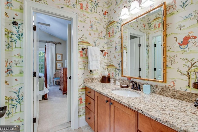 bathroom with vanity and lofted ceiling