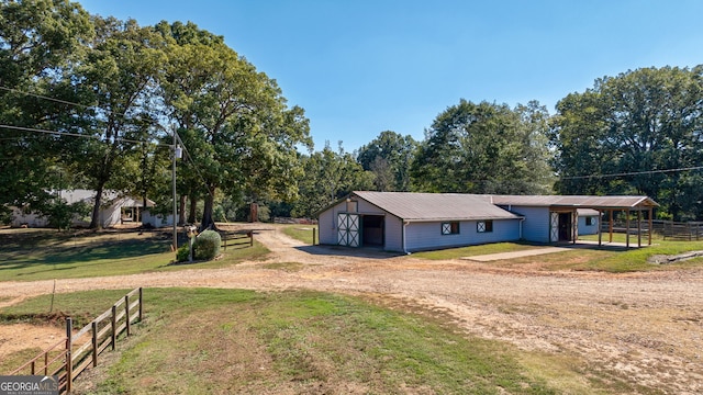 view of front of home with a front yard and an outbuilding