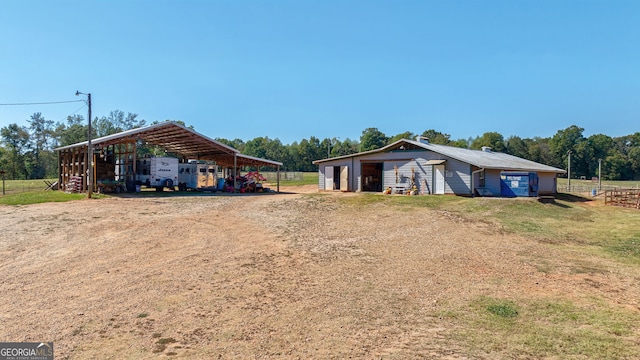 view of front of house with an outdoor structure and a carport