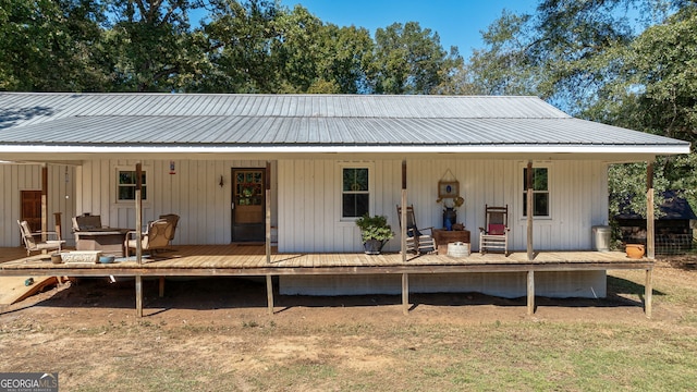 back of property with a wooden deck