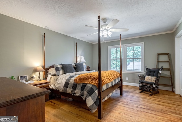 bedroom with ceiling fan, crown molding, and light wood-type flooring