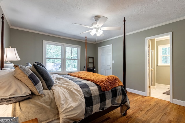 bedroom with crown molding, light hardwood / wood-style flooring, a textured ceiling, and ceiling fan