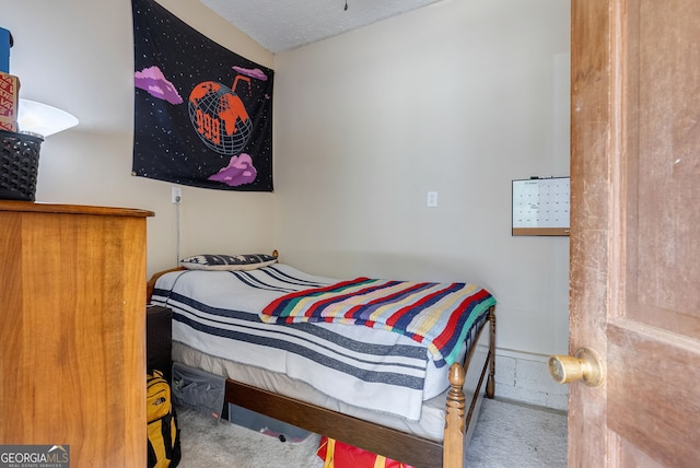 carpeted bedroom featuring a textured ceiling