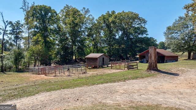 view of yard with a rural view and an outbuilding