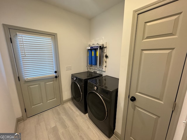 laundry room featuring independent washer and dryer and light wood-type flooring