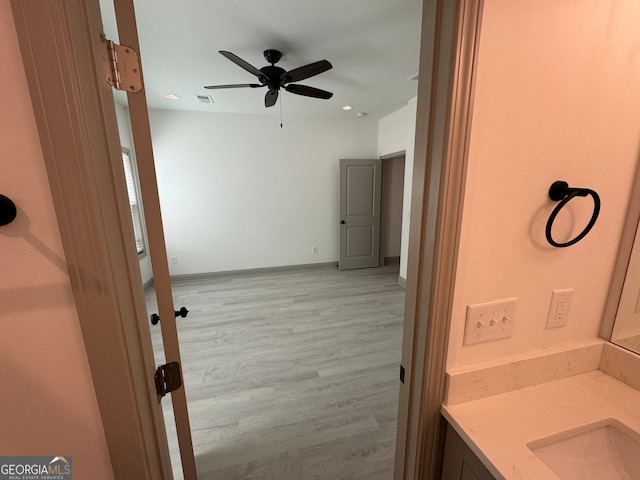 bathroom featuring vanity, ceiling fan, and wood-type flooring