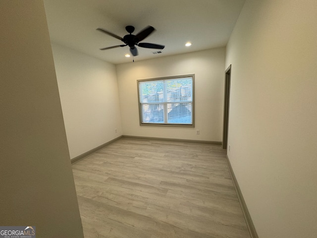 spare room featuring light wood-type flooring and ceiling fan