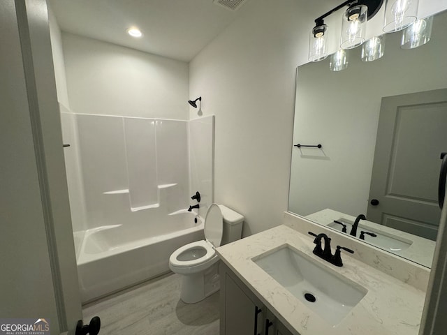 full bathroom featuring vanity, toilet, wood-type flooring, and washtub / shower combination