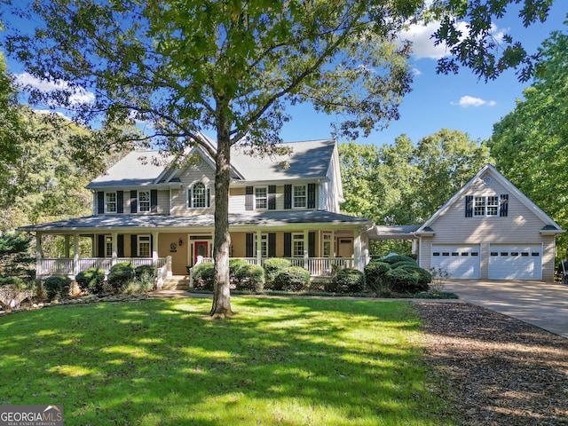 view of front of house featuring a porch, a front lawn, and a garage