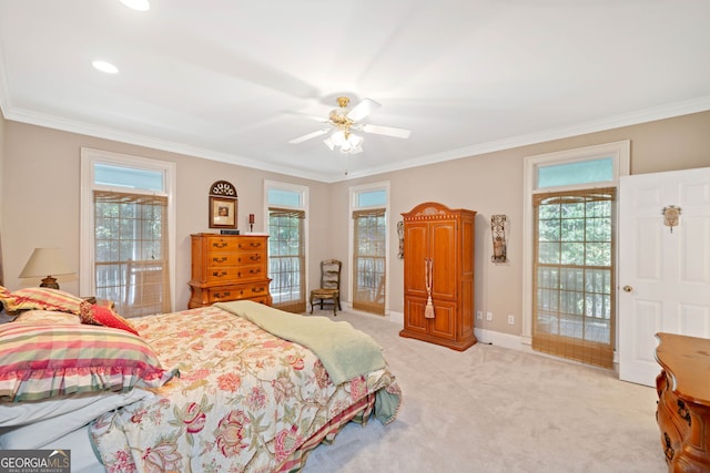 bedroom featuring ornamental molding, multiple windows, light colored carpet, and ceiling fan