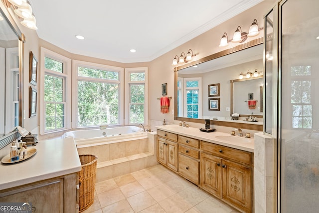 bathroom featuring vanity, plenty of natural light, and tiled tub