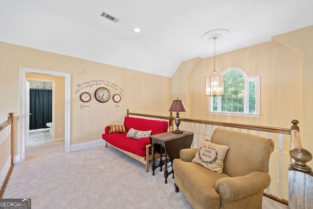 sitting room featuring light carpet, a notable chandelier, and vaulted ceiling