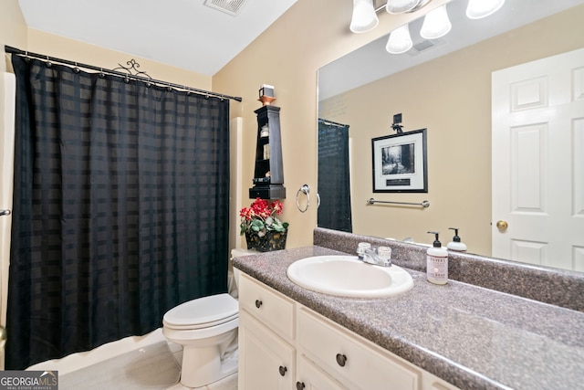 bathroom with vanity, a shower with shower curtain, toilet, and tile patterned floors