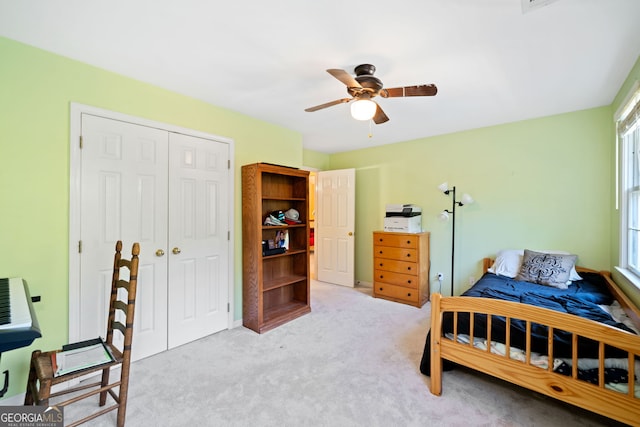 bedroom featuring a closet, ceiling fan, and light colored carpet