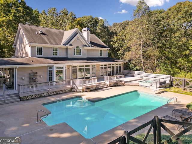 view of swimming pool featuring a patio and a wooden deck