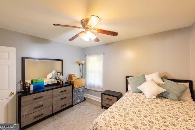 bedroom with light hardwood / wood-style flooring and ceiling fan