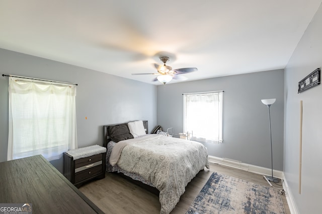 bedroom with hardwood / wood-style flooring and ceiling fan