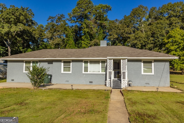 ranch-style house with a front lawn and a patio area